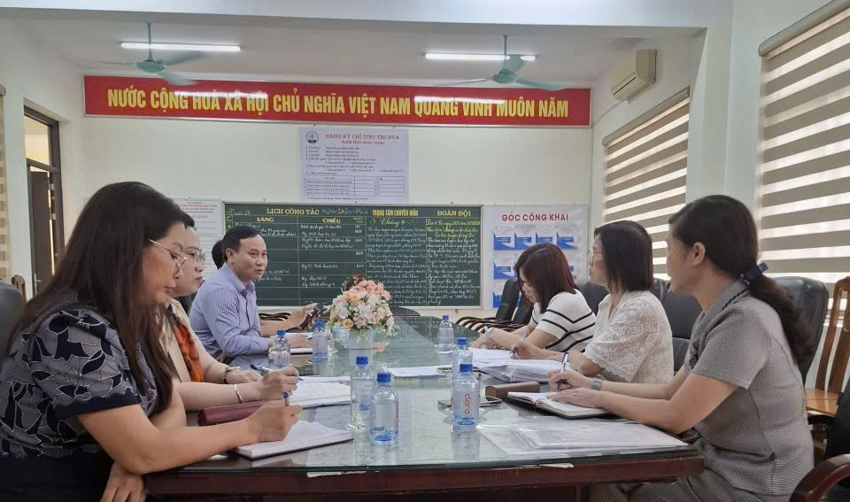 A group of people sitting at a table  AI-generated content may be incorrect.