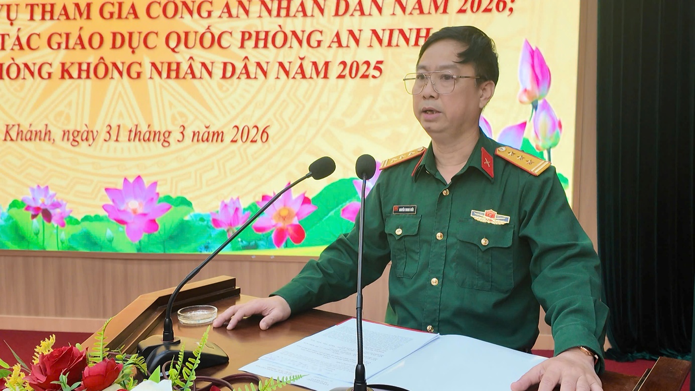 A person in uniform sitting at a desk with microphones  AI-generated content may be incorrect.