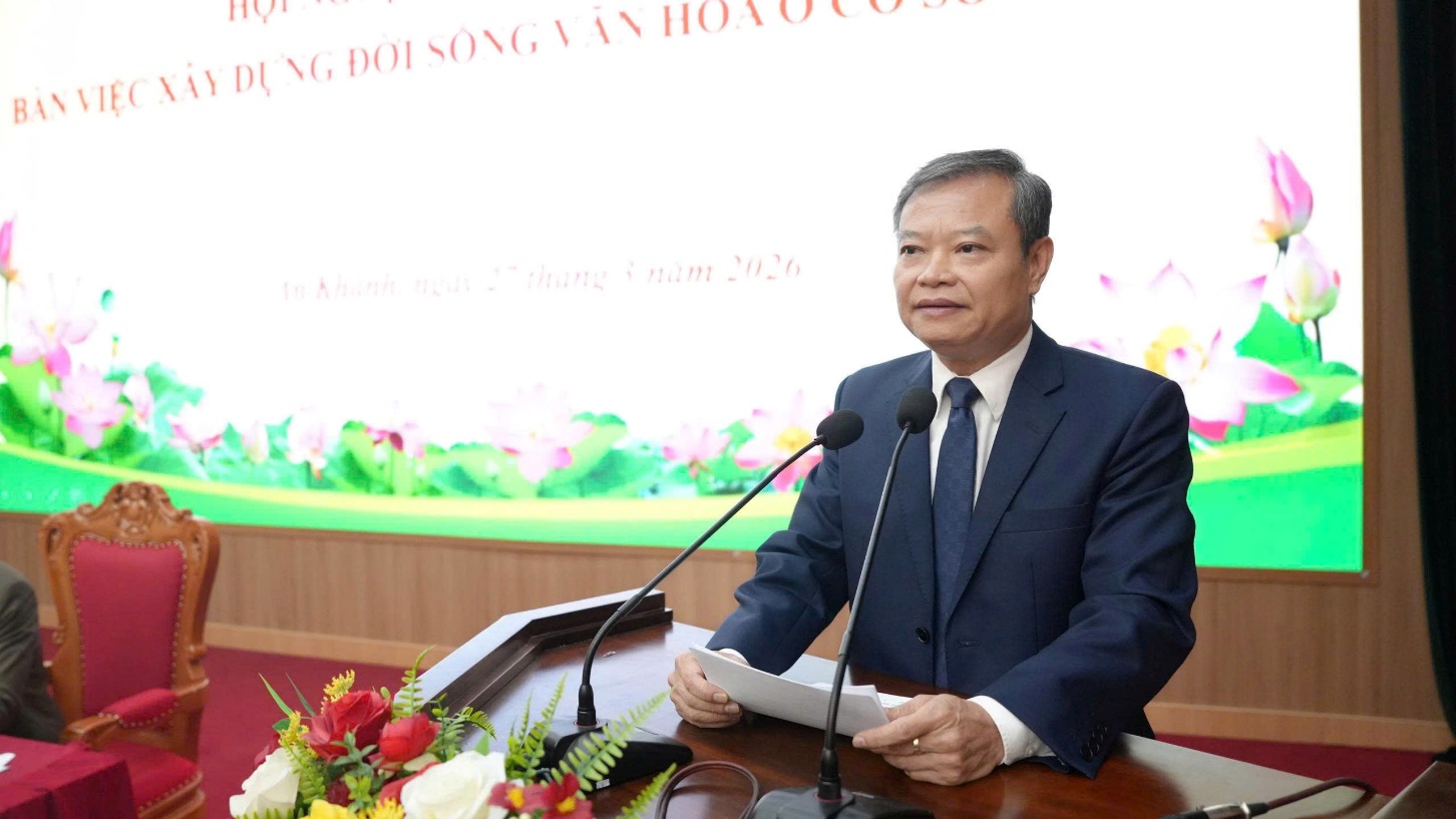 A person in a suit and tie standing at a podium with a microphone  AI-generated content may be incorrect.