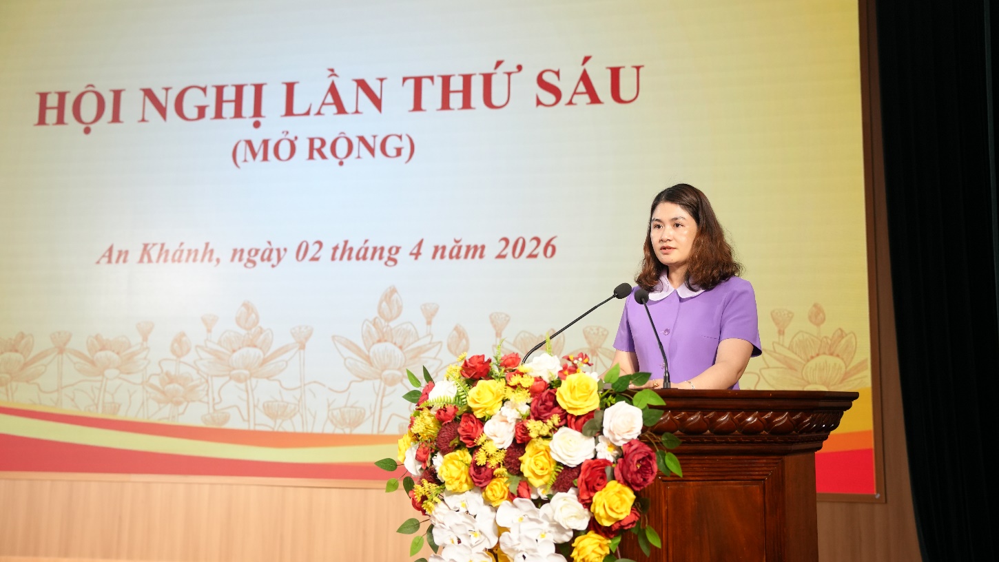 A person standing at a podium with a microphone and flowers  AI-generated content may be incorrect.