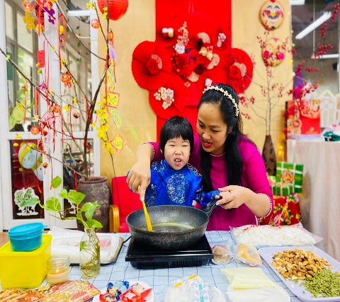 A person and child cooking  Description automatically generated