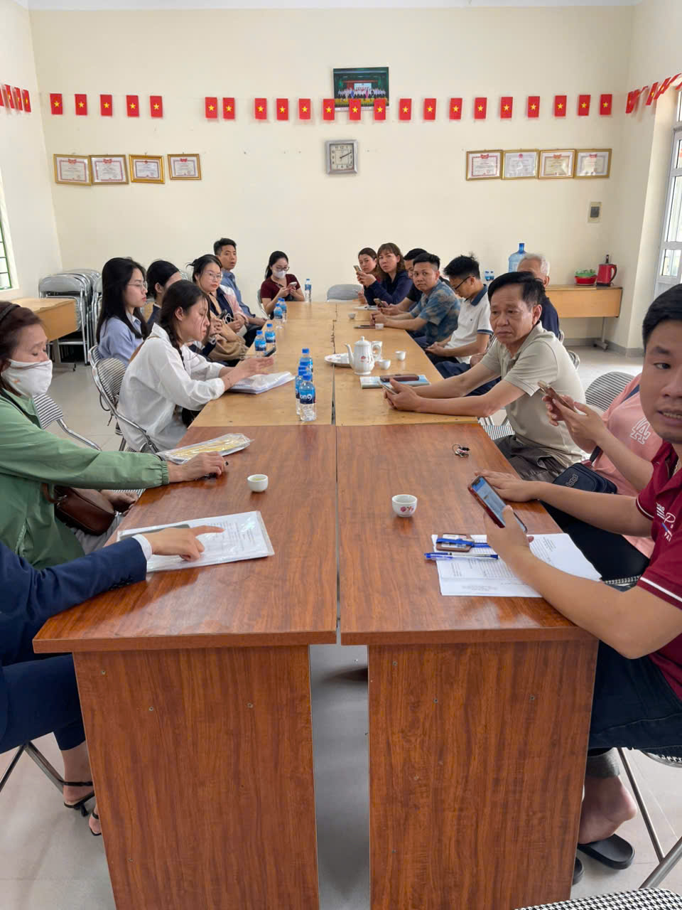 A group of people sitting at a table  AI-generated content may be incorrect.