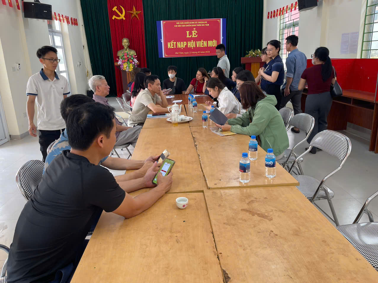 A group of people sitting at a long table  AI-generated content may be incorrect.