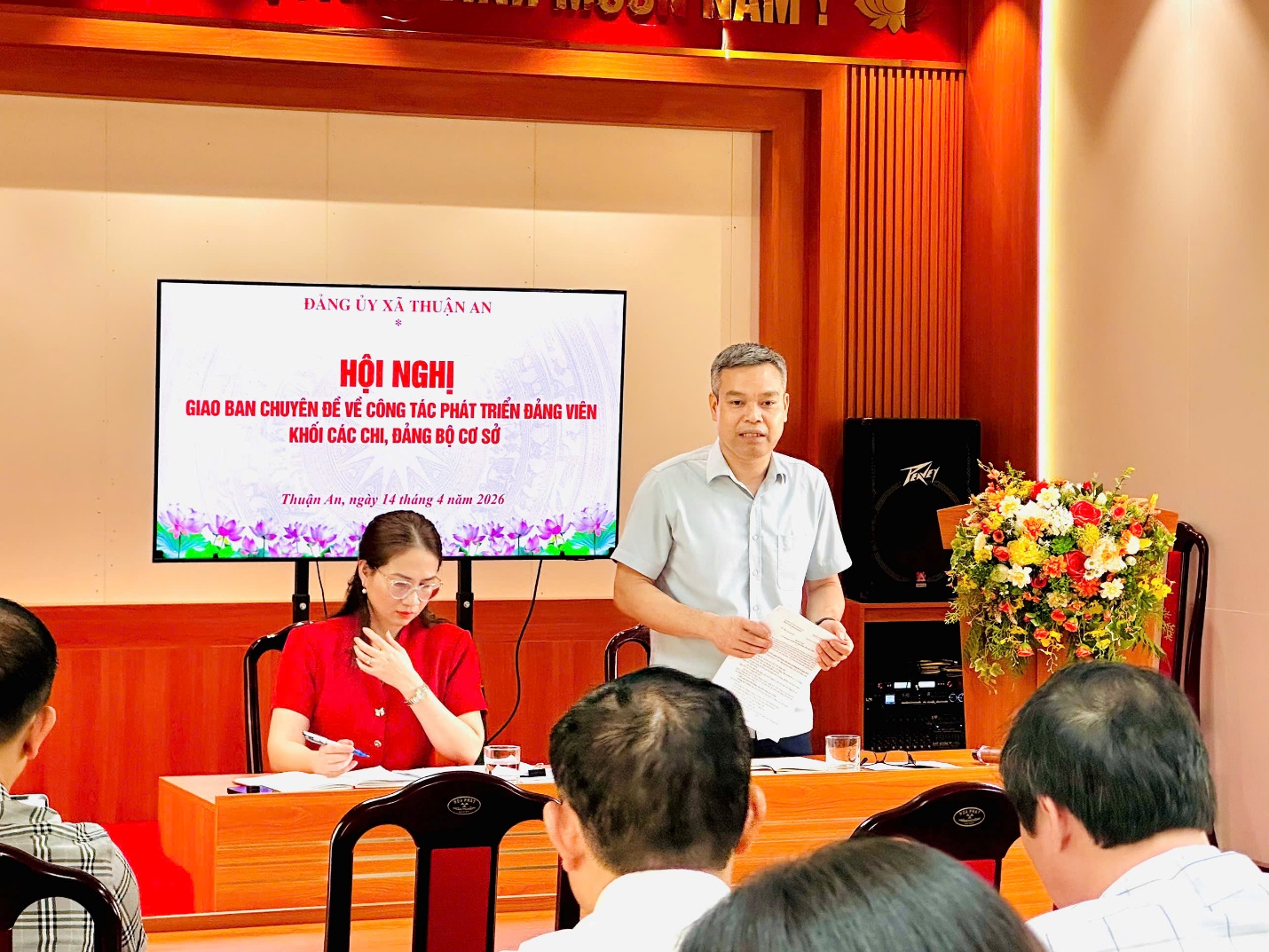 A person standing in front of a group of people  AI-generated content may be incorrect.