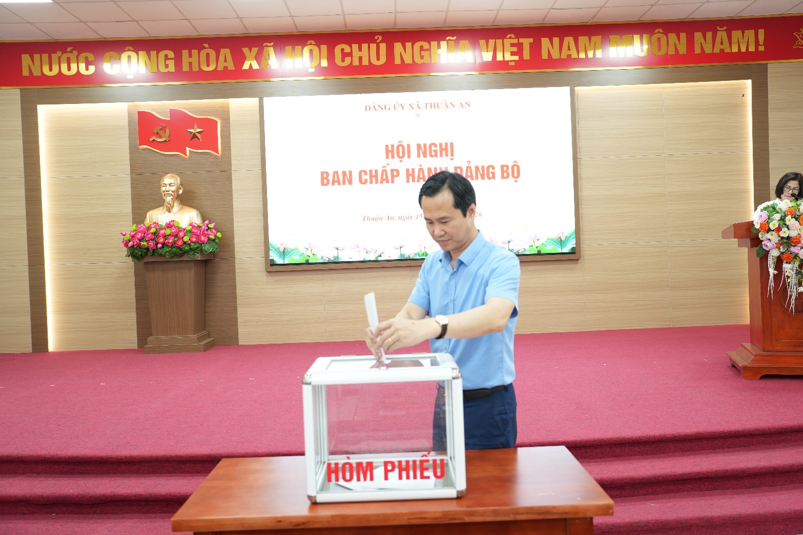 A person putting a ballot in a box  AI-generated content may be incorrect.