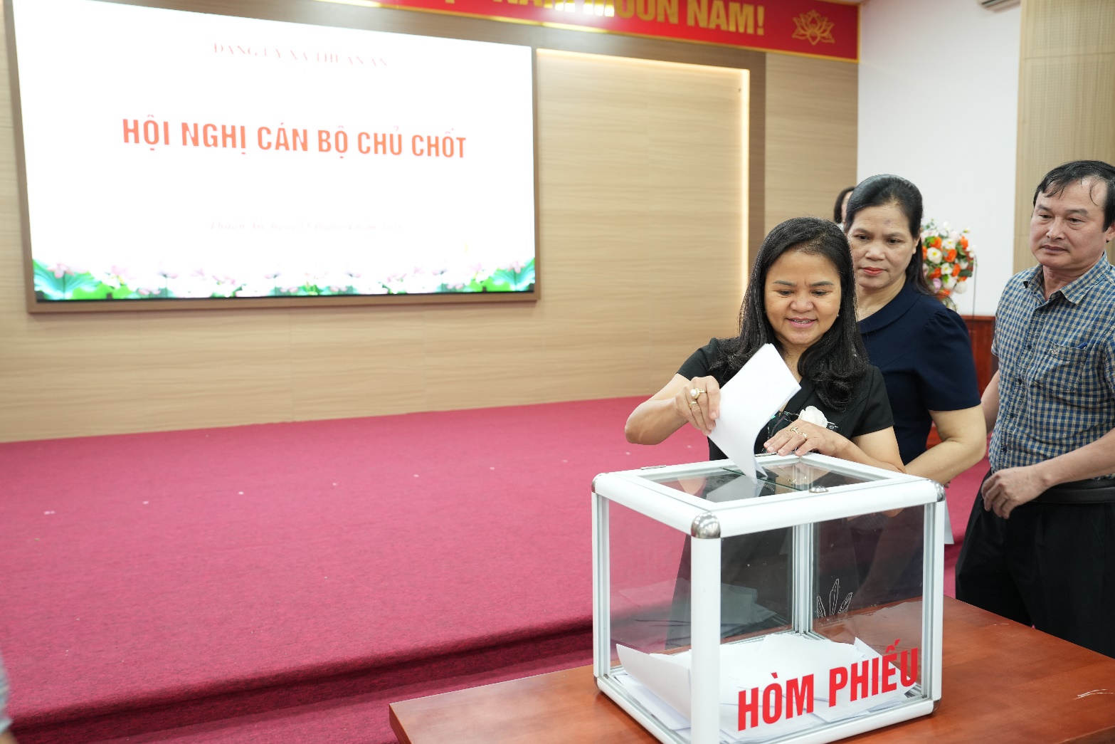 A group of women putting a ballot in a box  AI-generated content may be incorrect.