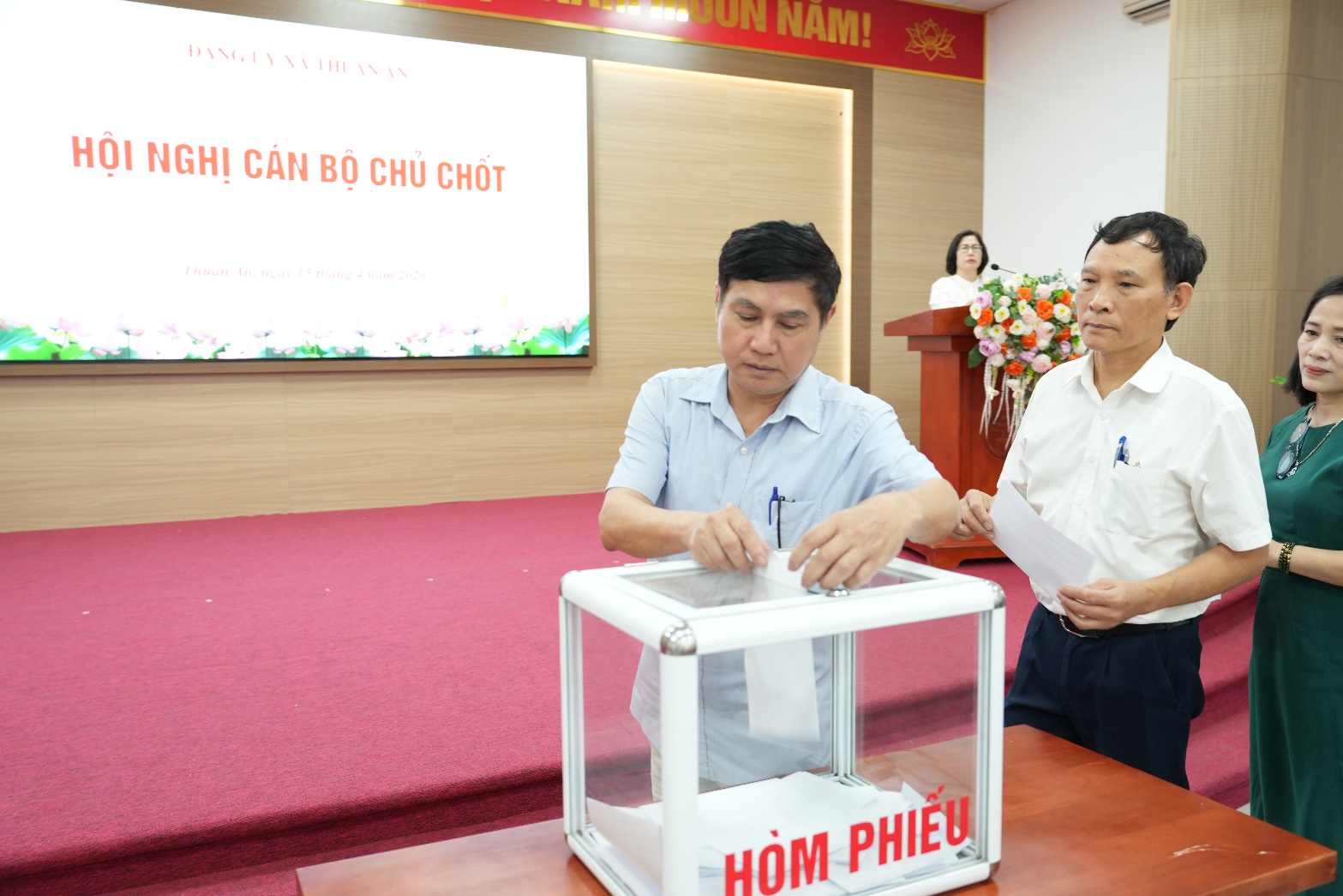 A person putting a ballot in a box  AI-generated content may be incorrect.