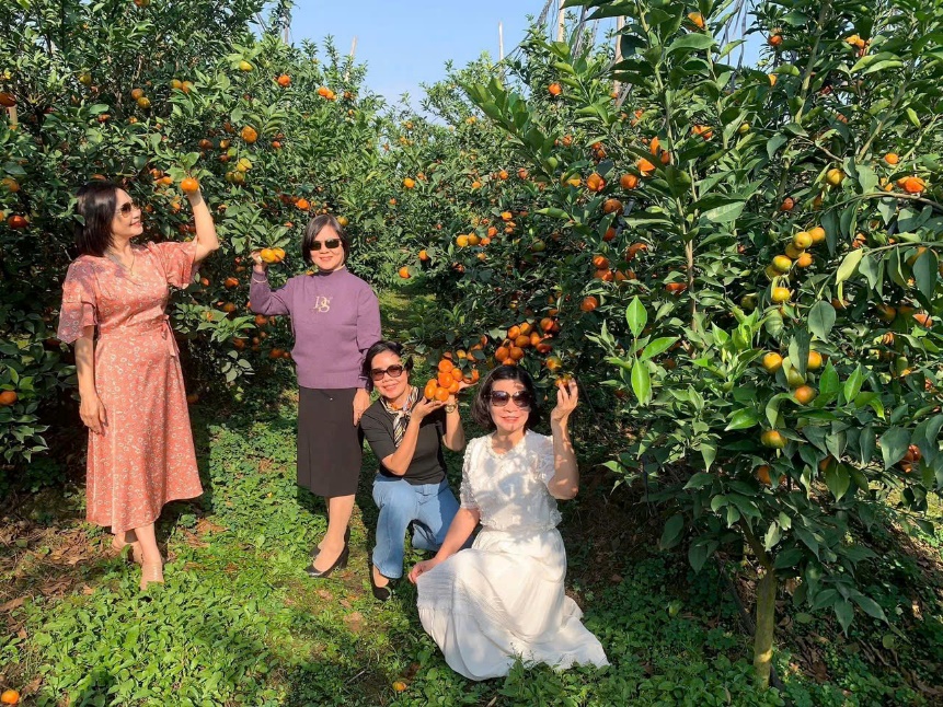 A group of women posing for a picture in a garden  AI-generated content may be incorrect.