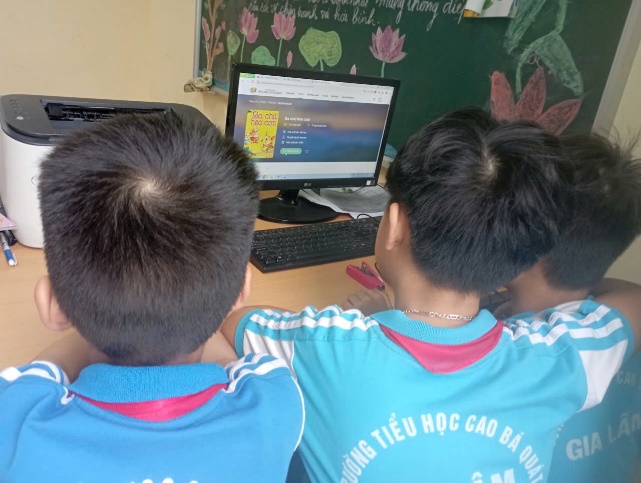 A group of boys looking at a computer  AI-generated content may be incorrect.