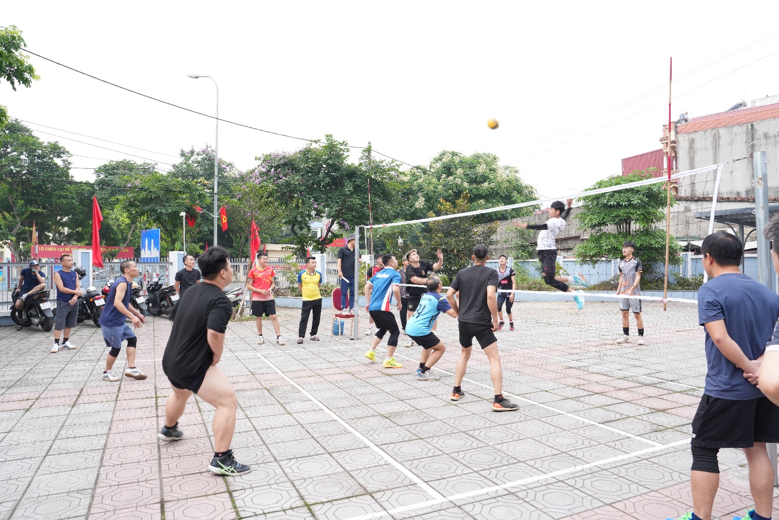 A group of people playing volleyball  AI-generated content may be incorrect.