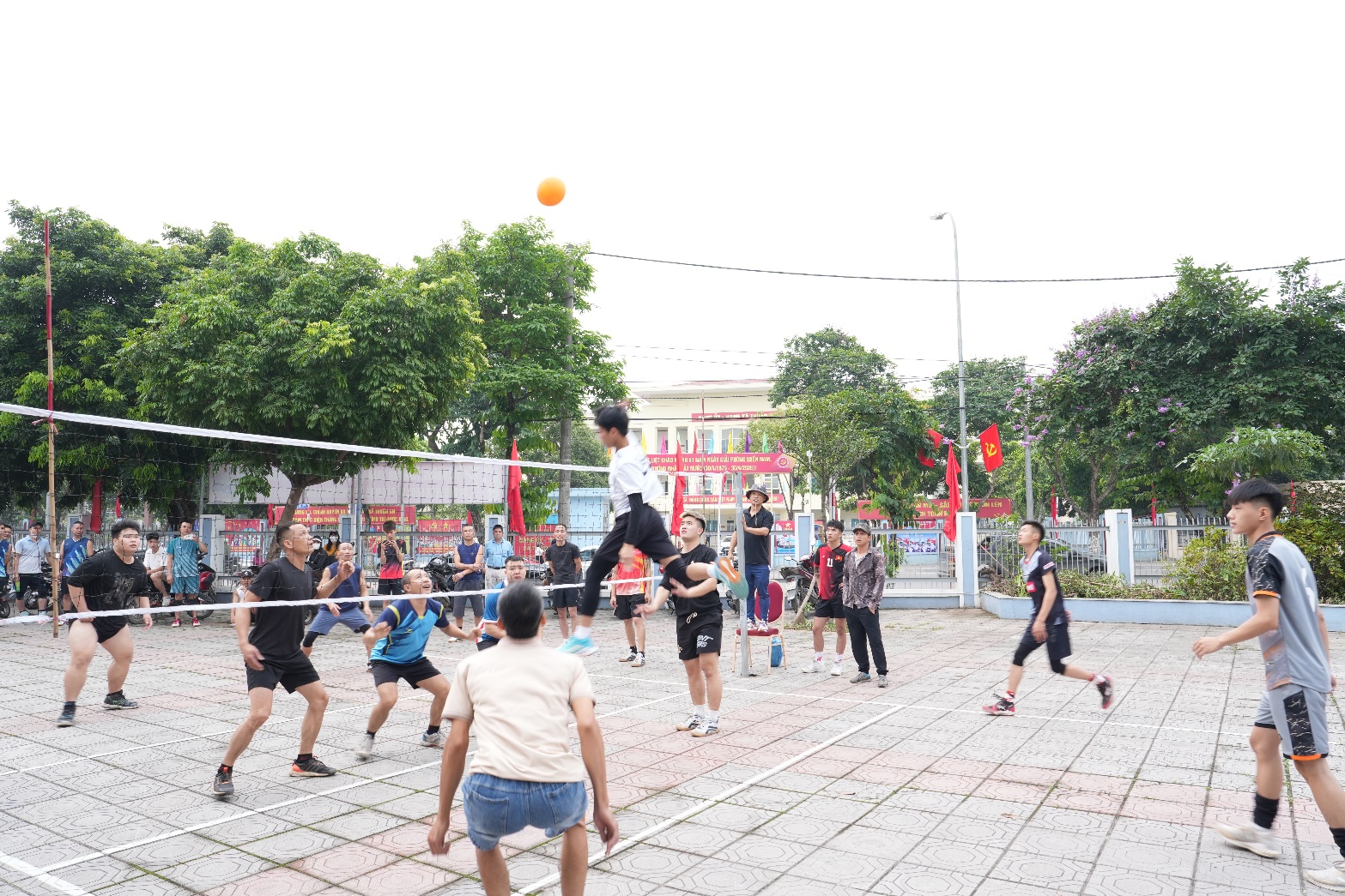 A group of people playing volleyball  AI-generated content may be incorrect.