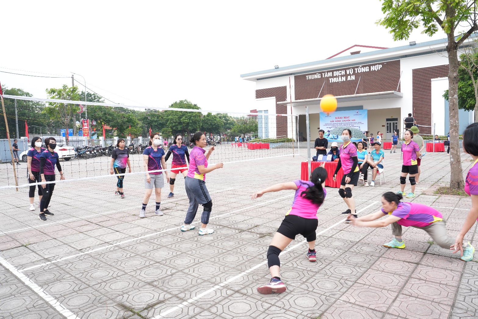 A group of people playing volleyball  AI-generated content may be incorrect.