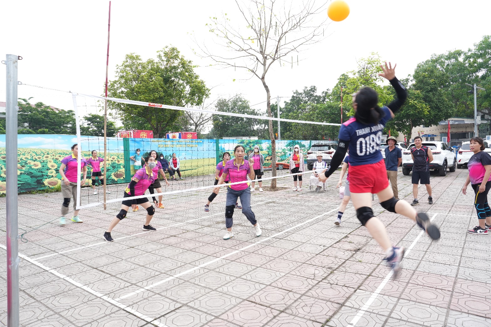 A group of people playing volleyball  AI-generated content may be incorrect.