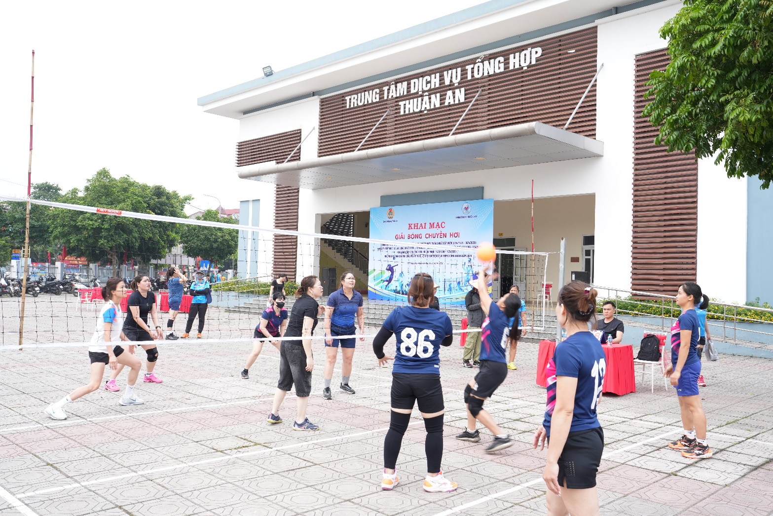 A group of people playing volleyball  AI-generated content may be incorrect.