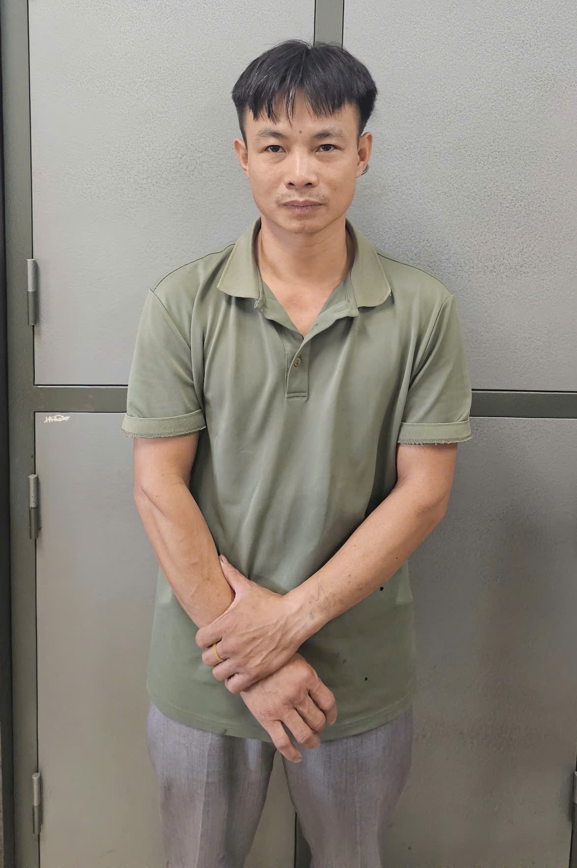 A person standing in front of a locker  Description automatically generated