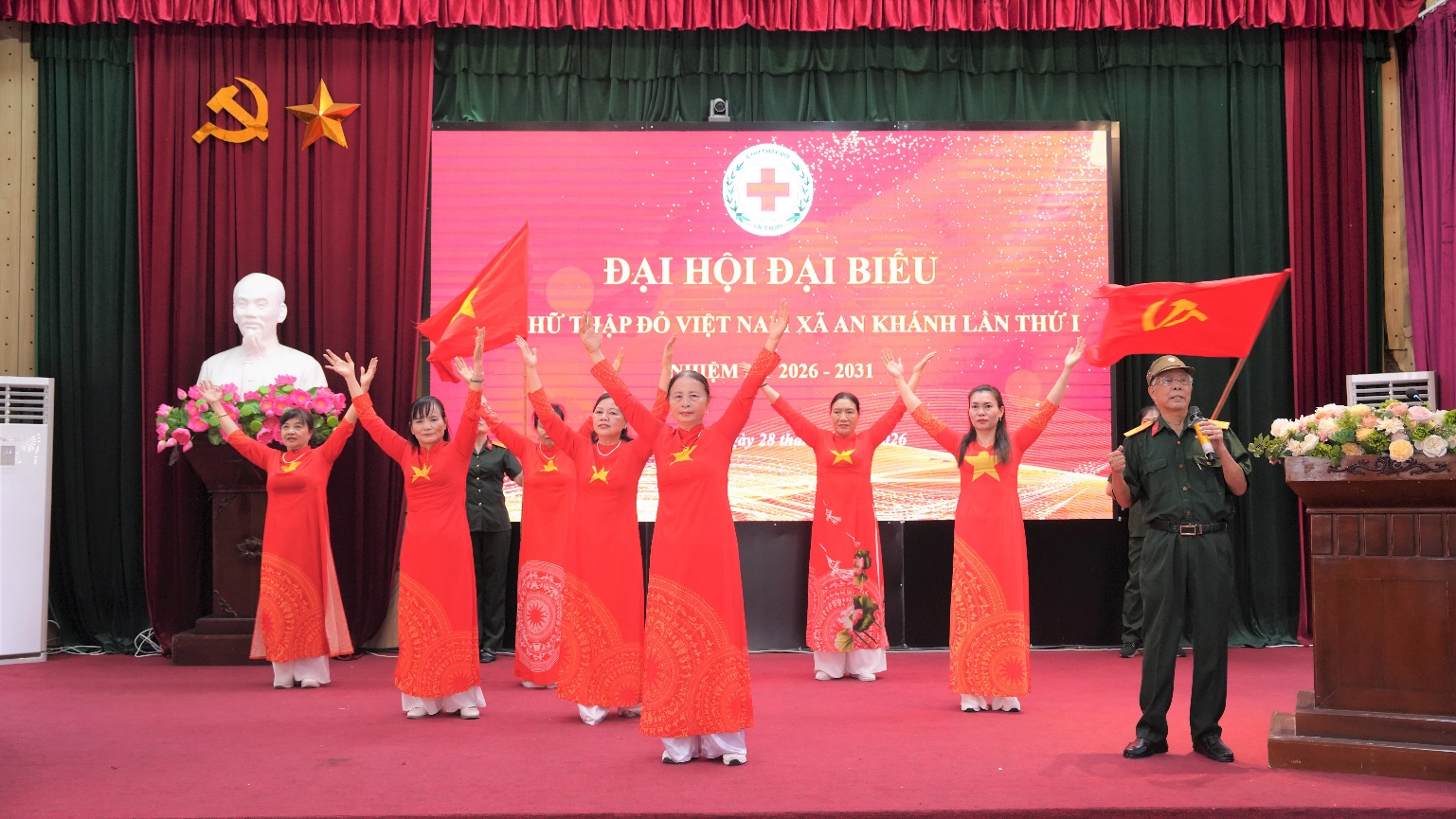 A group of people in red dresses on a stage  AI-generated content may be incorrect.