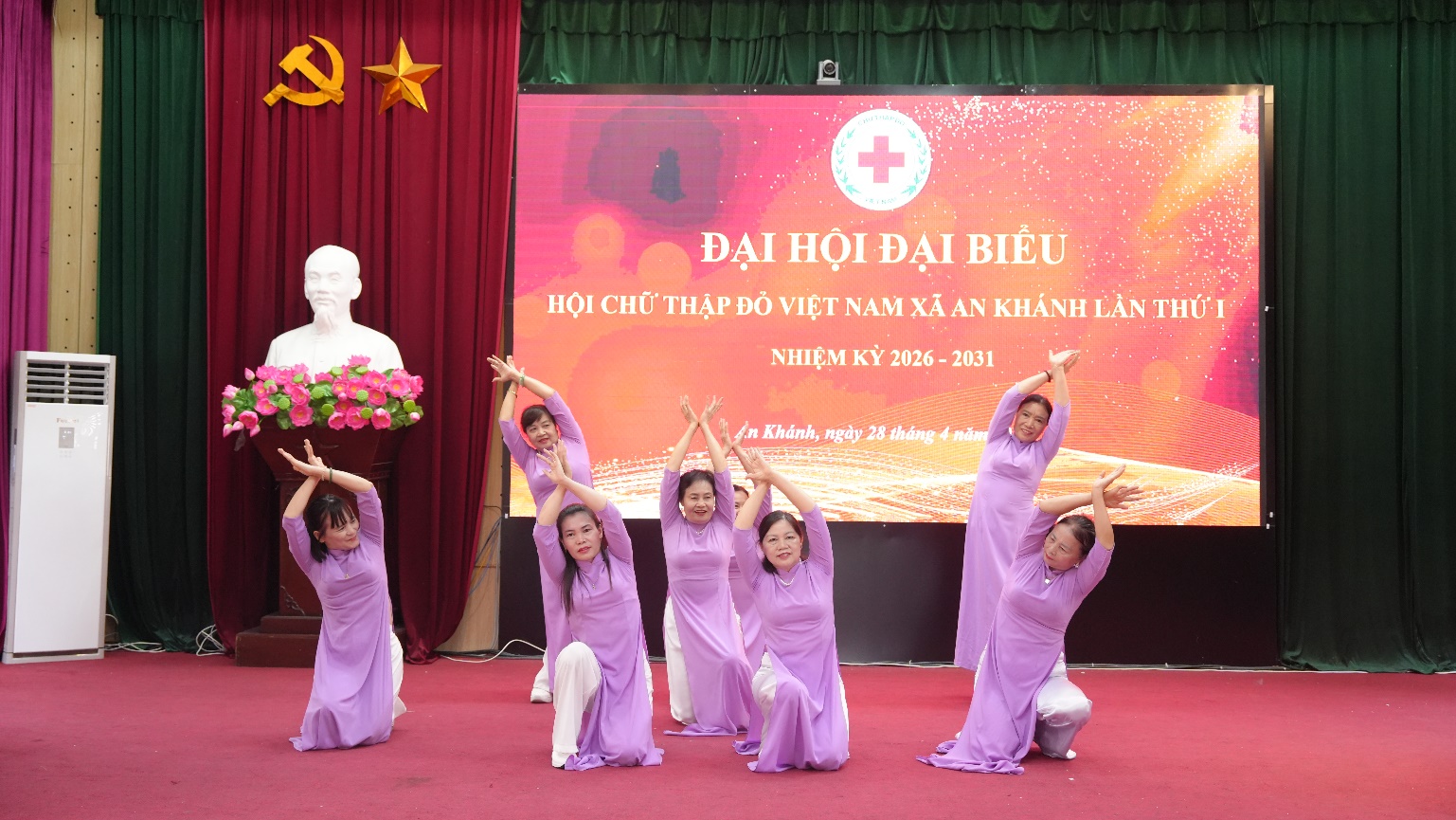 A group of people in purple dresses on a stage  AI-generated content may be incorrect.