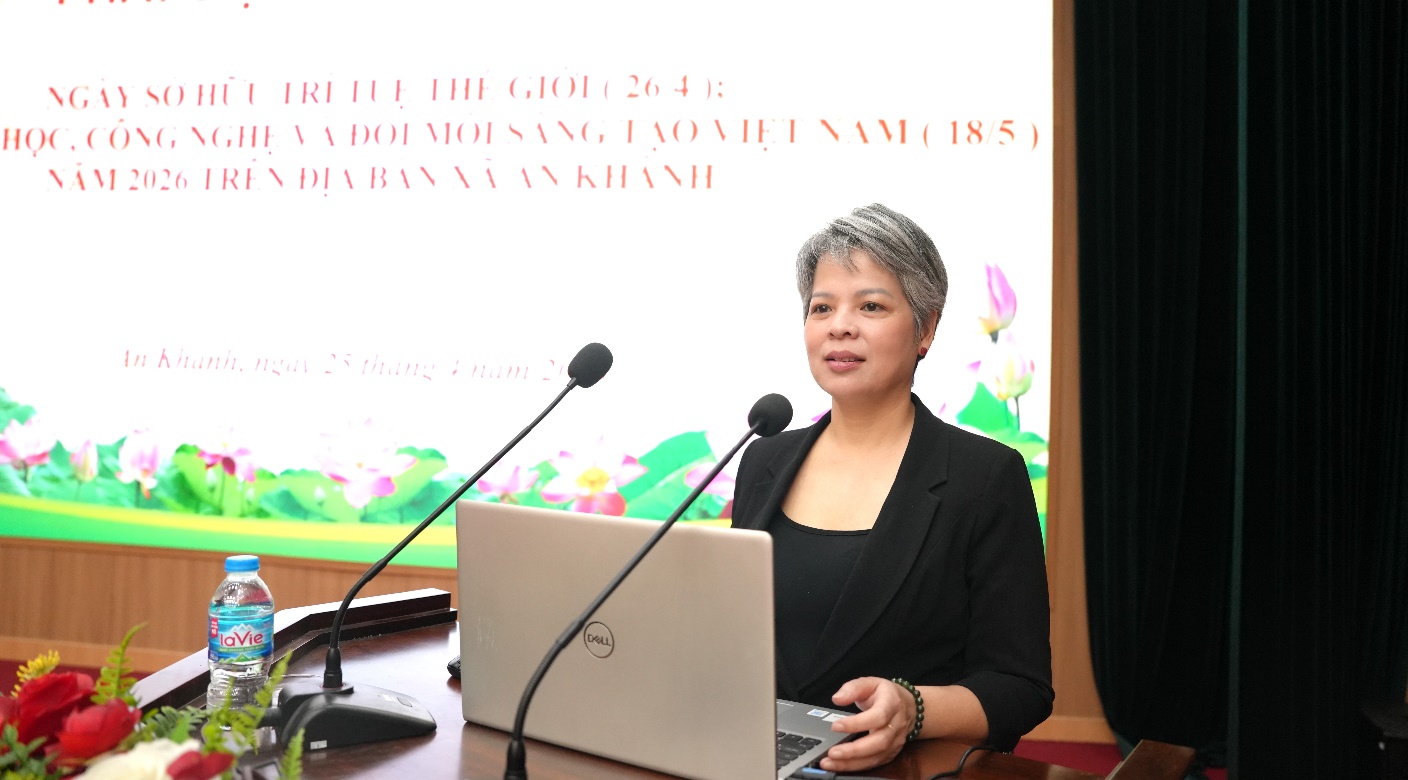 A person sitting at a podium with a computer and microphones  AI-generated content may be incorrect.