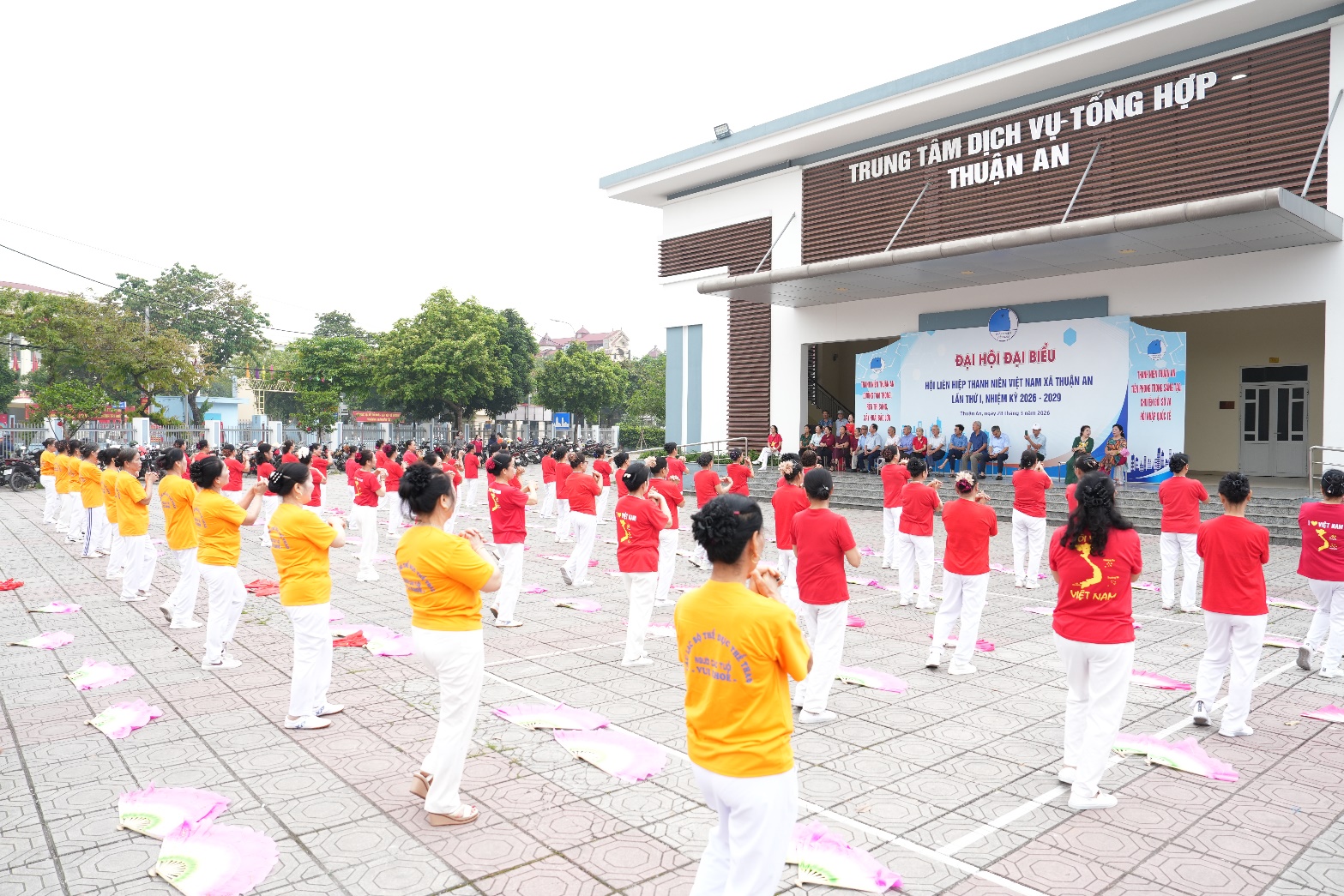 A group of people in red shirts and white pants  AI-generated content may be incorrect.