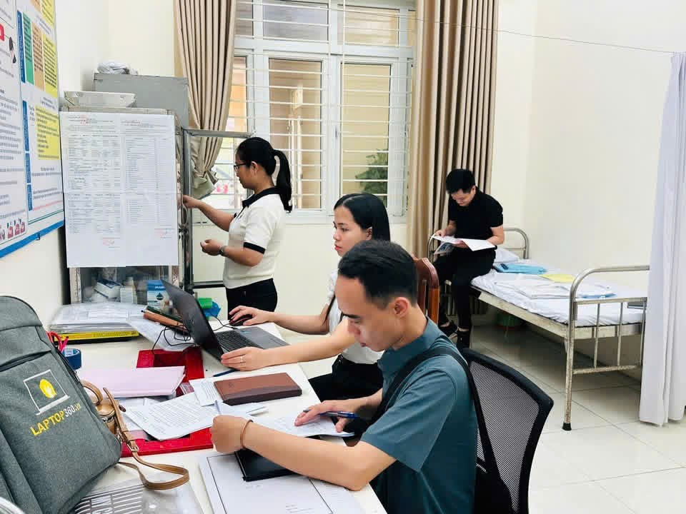 A group of people working on computers  Description automatically generated