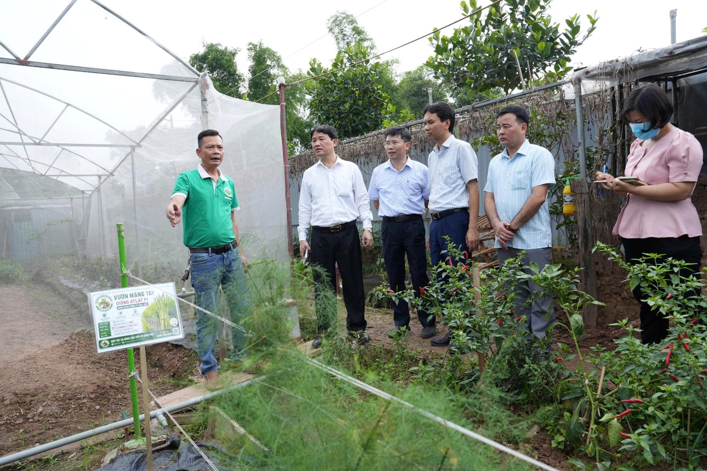 A group of men standing in a garden  AI-generated content may be incorrect.