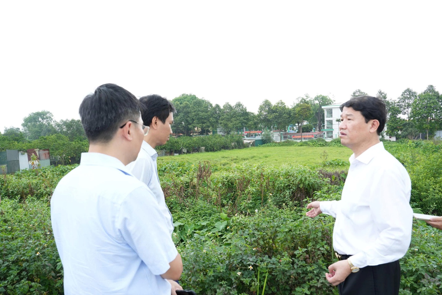 A group of men standing in a field  AI-generated content may be incorrect.