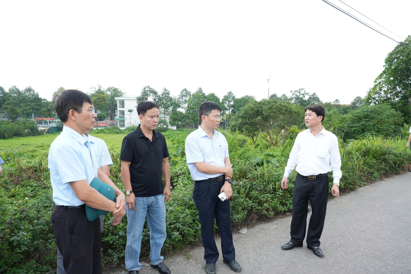 A group of men standing on a road  AI-generated content may be incorrect.