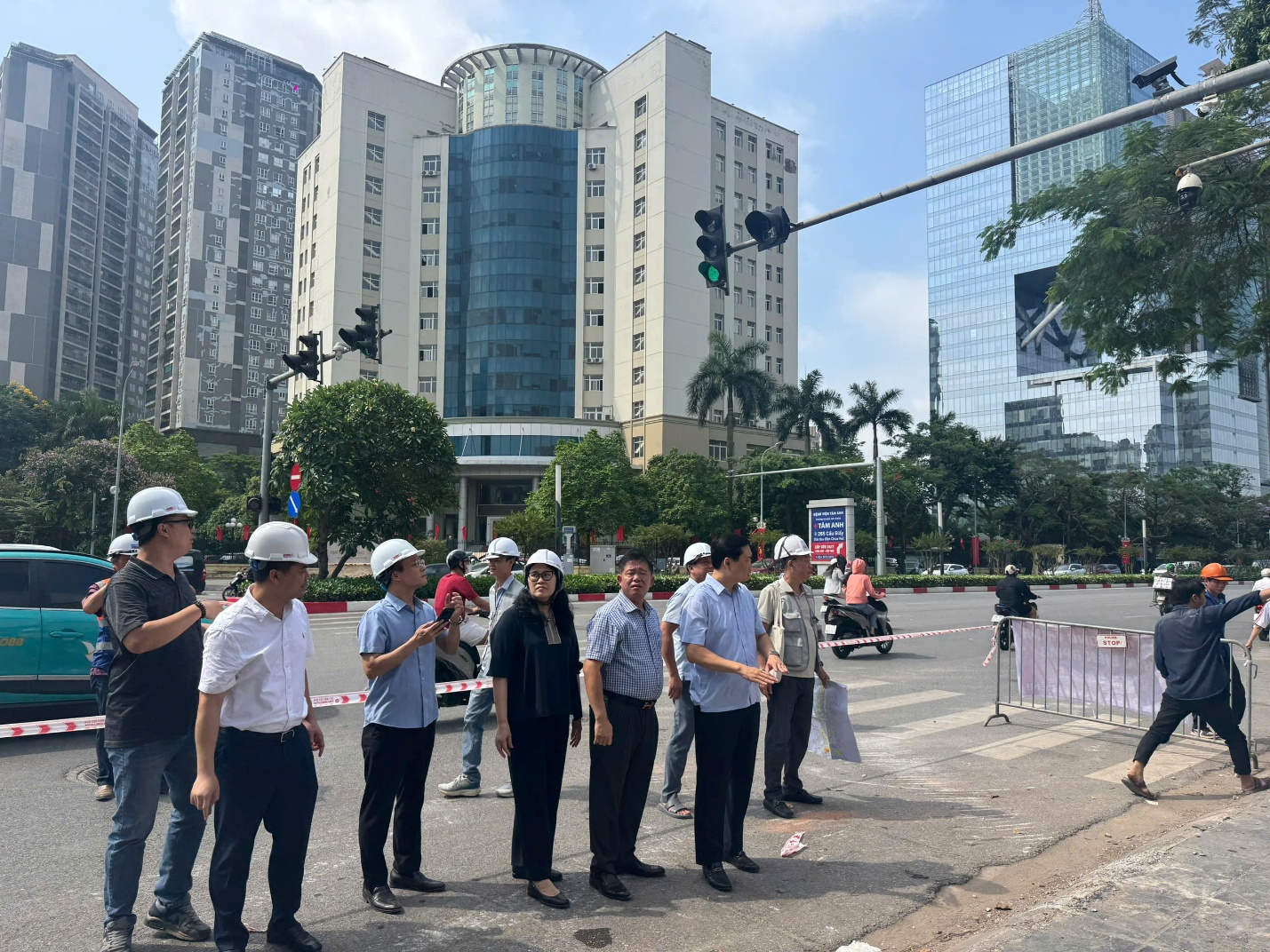 A group of people in hard hats standing on a street  AI-generated content may be incorrect.