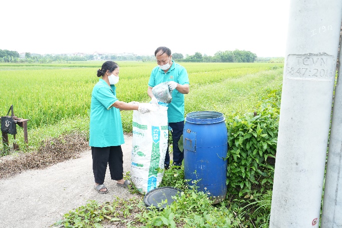 A couple of people putting garbage in a bag  AI-generated content may be incorrect.