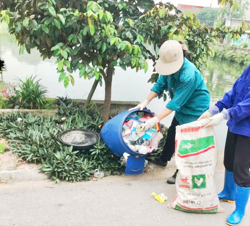 A group of people collecting garbage  AI-generated content may be incorrect.