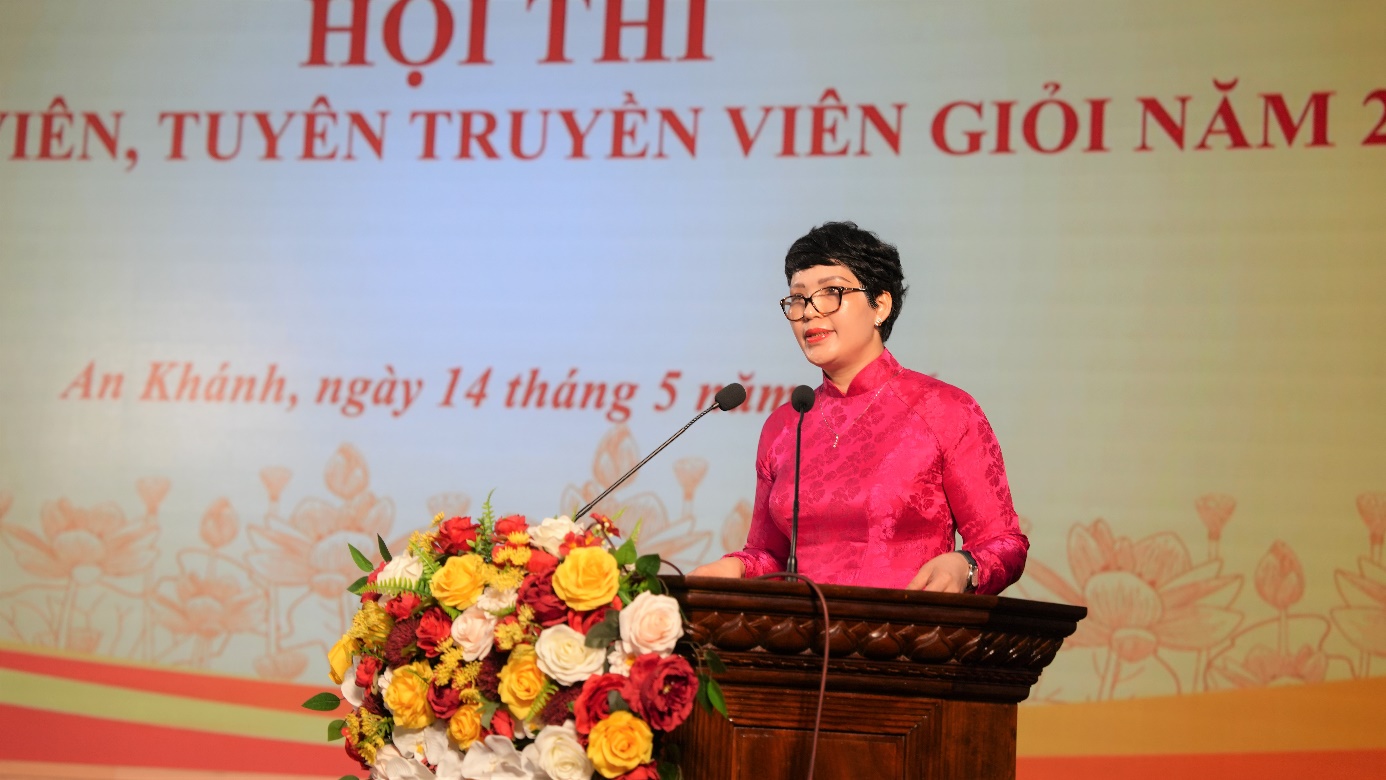A person standing at a podium with a microphone and flowers  AI-generated content may be incorrect.