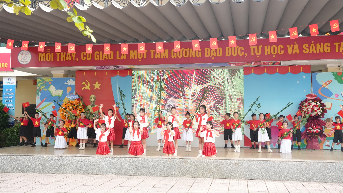 A group of children performing on a stage  AI-generated content may be incorrect.
