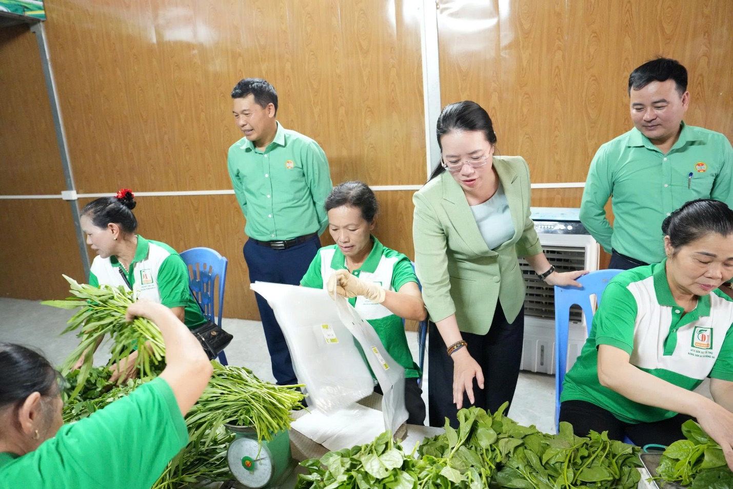 A group of people in green shirts  AI-generated content may be incorrect.