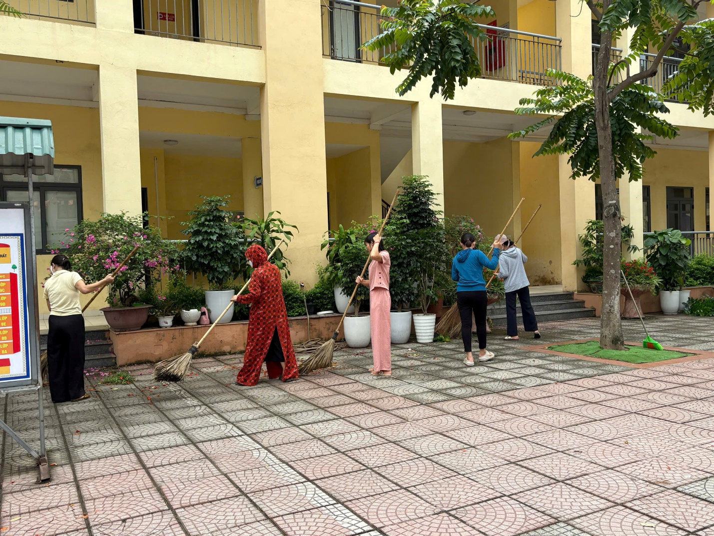 A group of people sweeping the ground  AI-generated content may be incorrect.