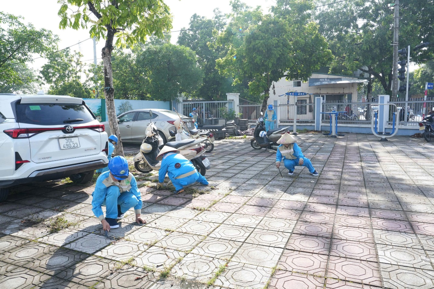 A group of people in blue overalls on a brick patio  AI-generated content may be incorrect.