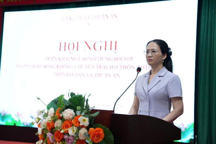 A person standing at a podium with a microphone  AI-generated content may be incorrect.