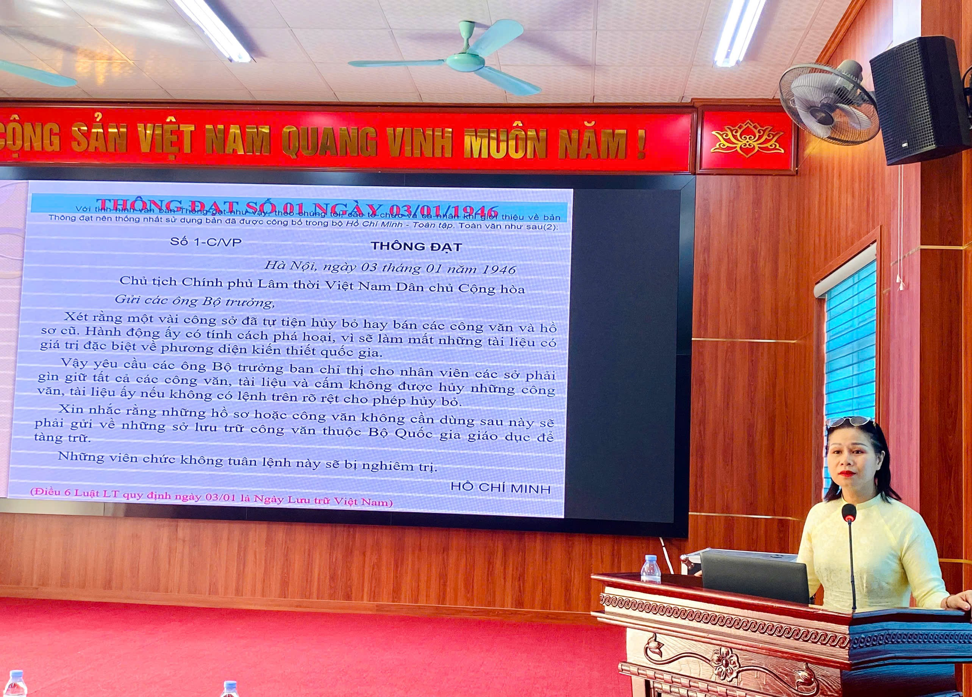 A person in a room with a large screen  Description automatically generated
