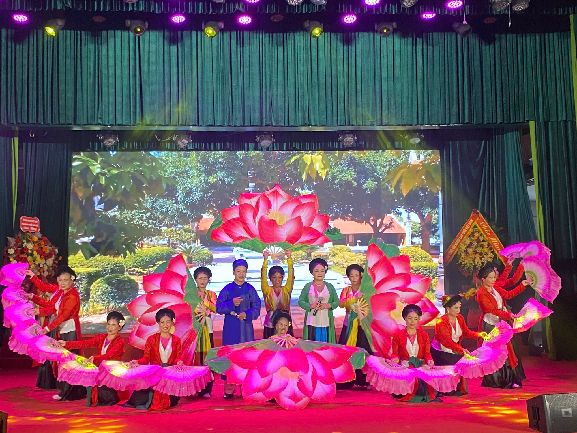 A group of people performing on stage  Description automatically generated