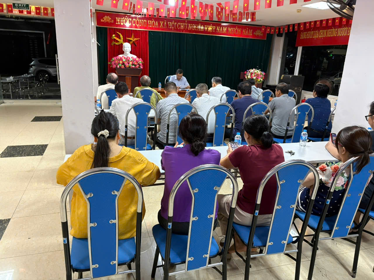 A group of people sitting at a table  AI-generated content may be incorrect.